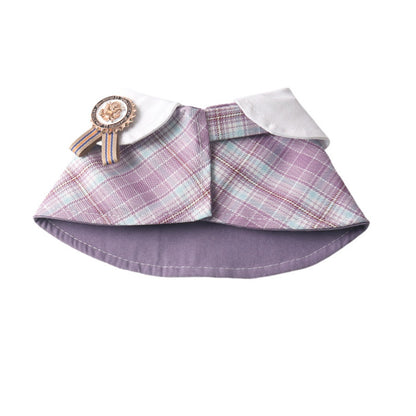 Close-up of Mokka plaid rosette cape collar showing fabric pattern and rosette detail