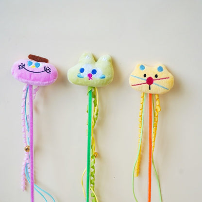 Moo plush cat teaser wand with soft fabric and colorful feathers on a wooden stick