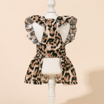 Leopard dog dress laid flat, highlighting the bow and fabric texture