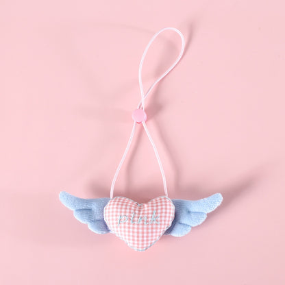 Mokka cat collar with winged heart charm laid out with charm facing forward