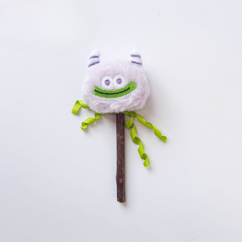 Moo monster cat toy held by hand showing size and feather details