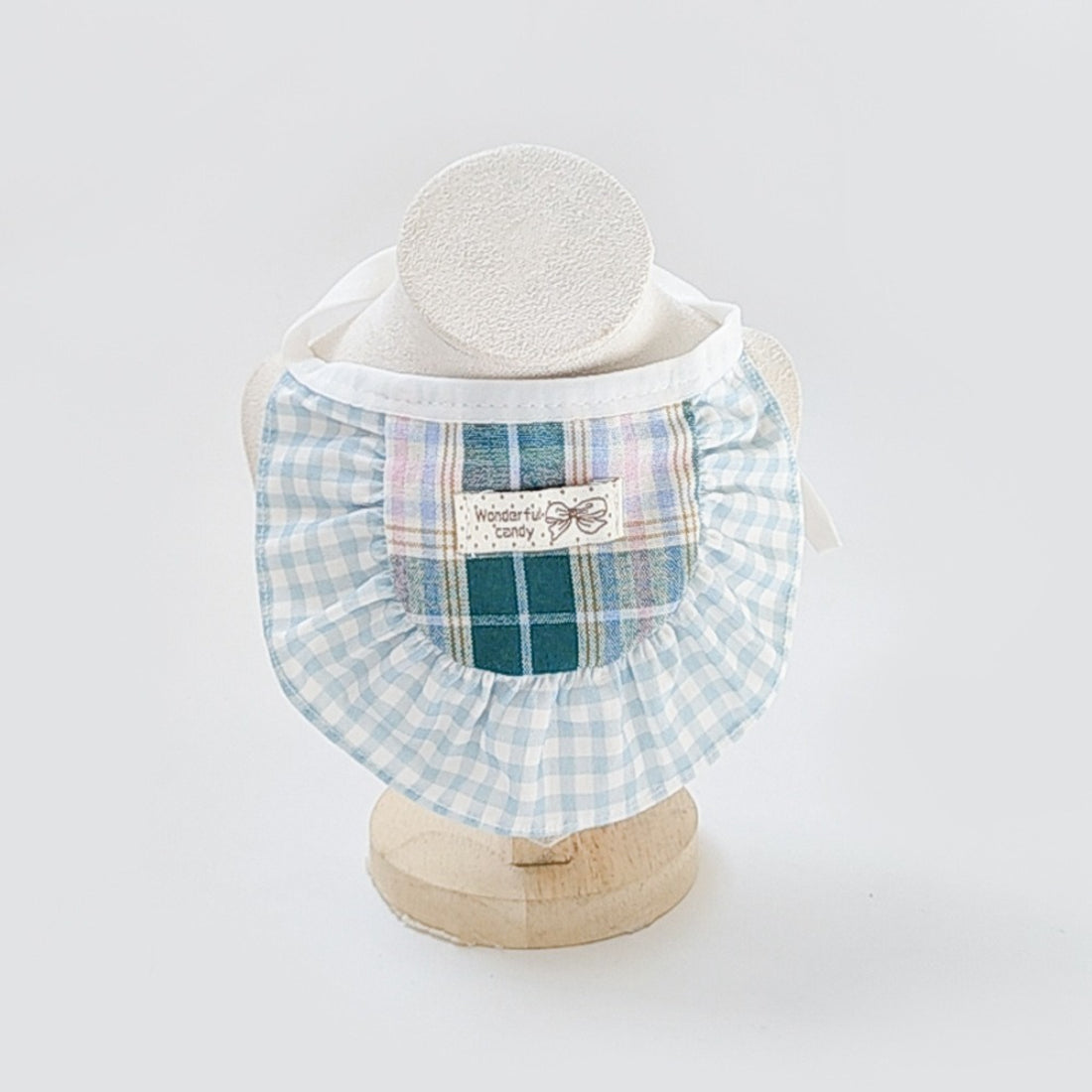 Mokka Sweet Patch Cat Bib worn by a baby, showing front view with cat patch