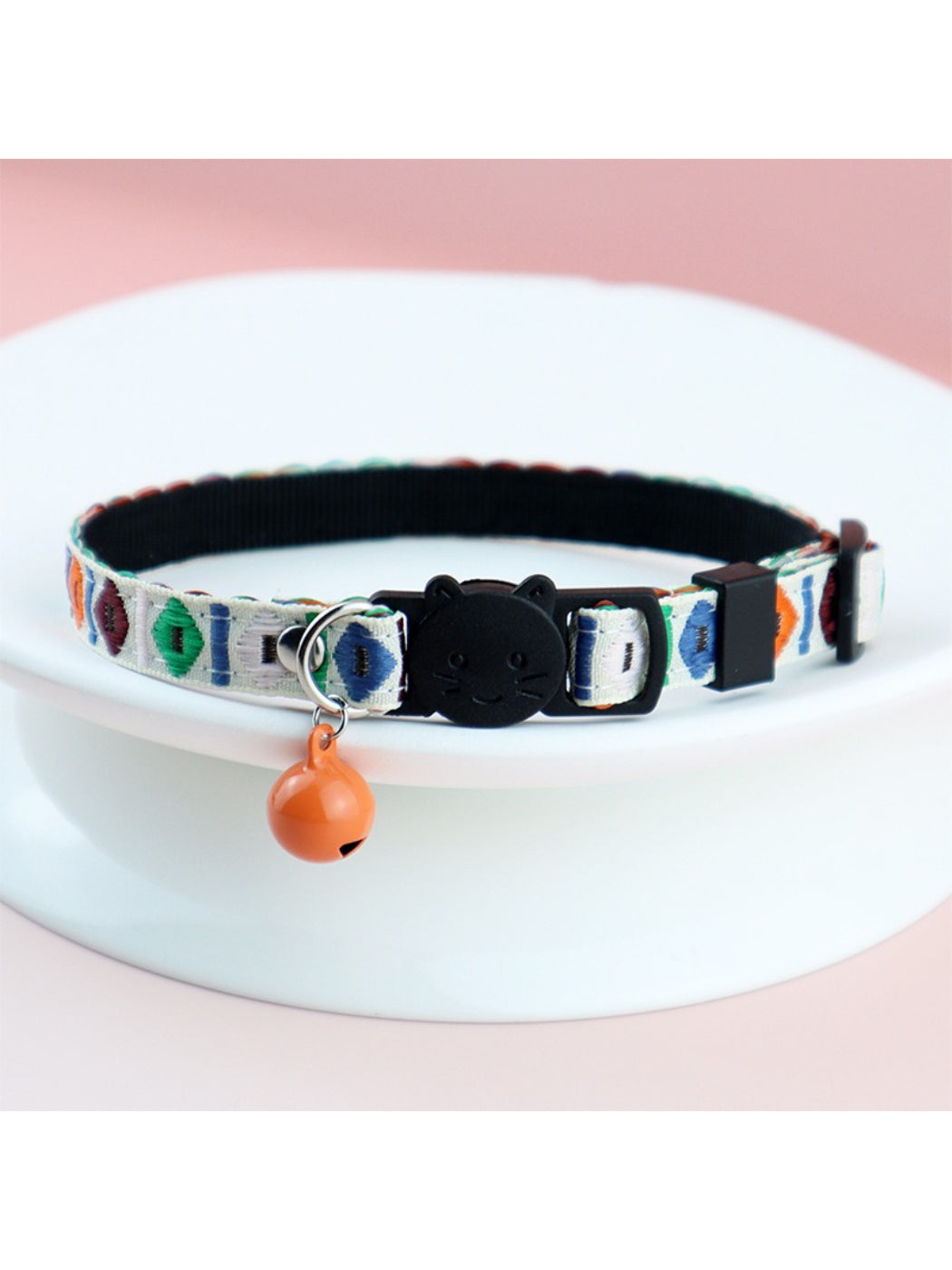 Mokka woven cat collar partially coiled showing flexibility and vibrant colors