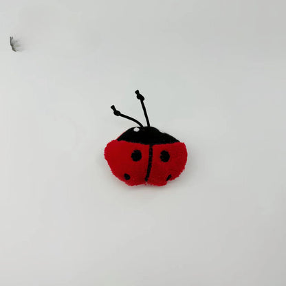 Moo plush insect cat toy lying flat with detailed stitching visible