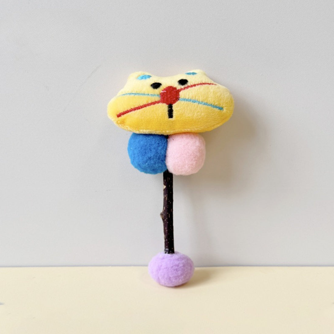 Moo cat stick toy displayed on a white background highlighting colors and details