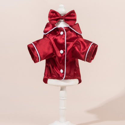 Close-up of satin dog shirt with a large bow on the back, displayed on a small dog