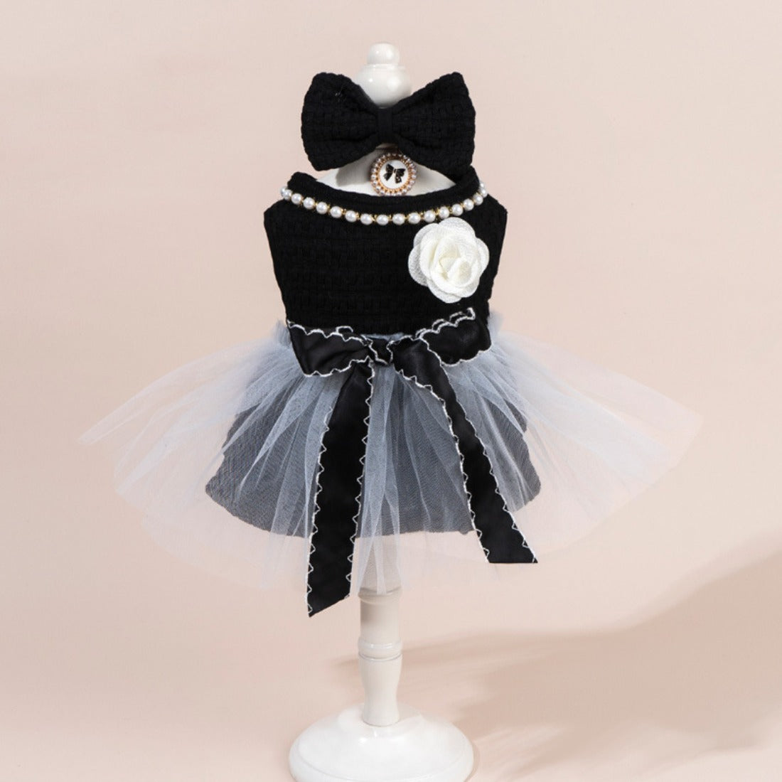 Side view of Ozzie cat in a tulle dress with bow detail on the back