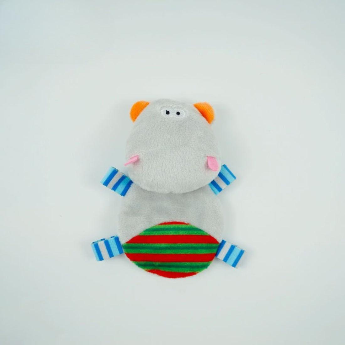 Child playing with Moo interactive hippo cat plush toy on a wooden floor