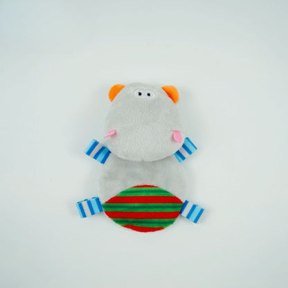 Child playing with Moo interactive hippo cat plush toy on a wooden floor