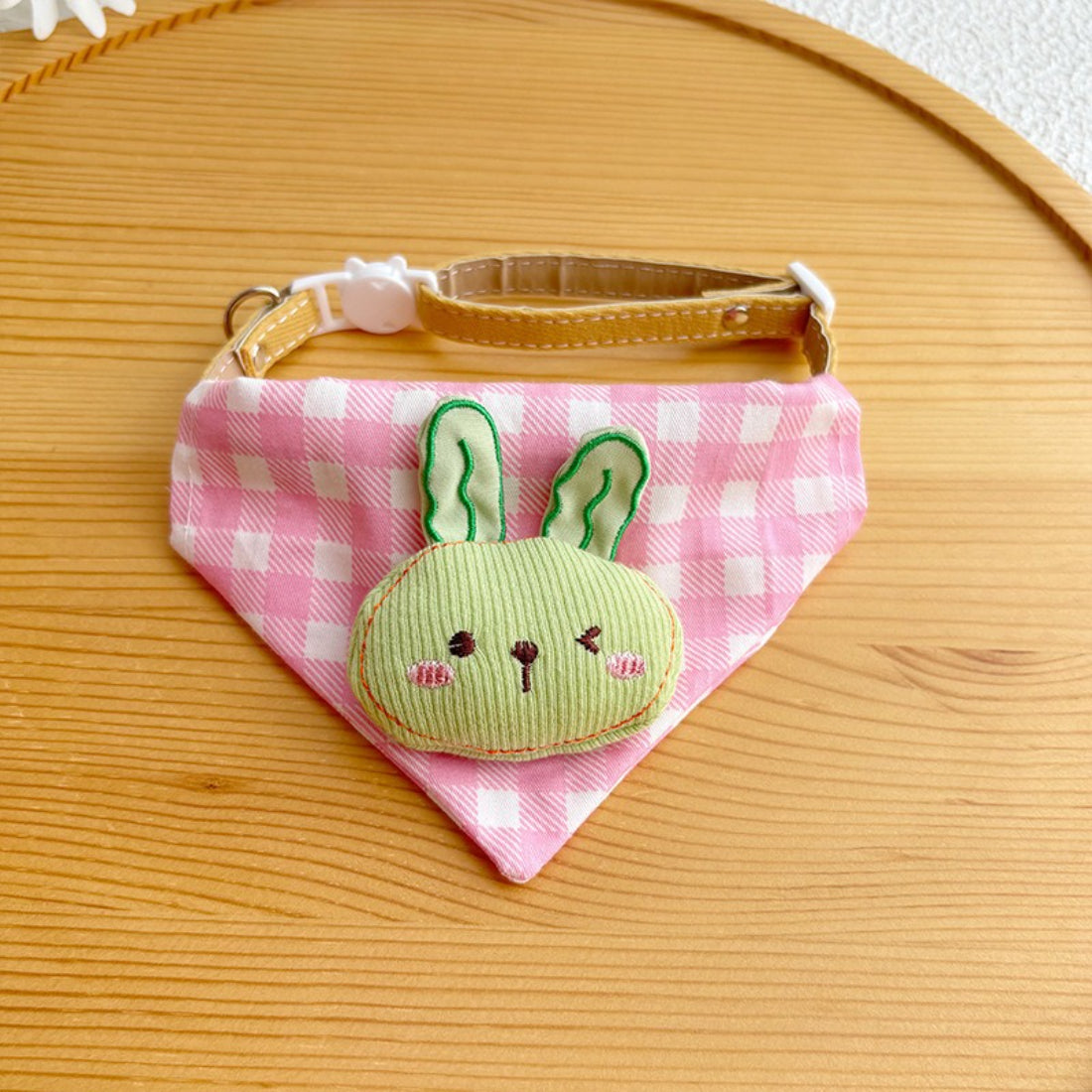 Side view of cat with pink gingham bandana around neck