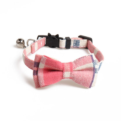 Mokka cat collar with plaid bow tie laid out next to measuring tape for size reference