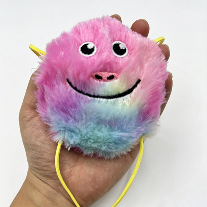 Close-up of a furry smiling cat toy held in a hand