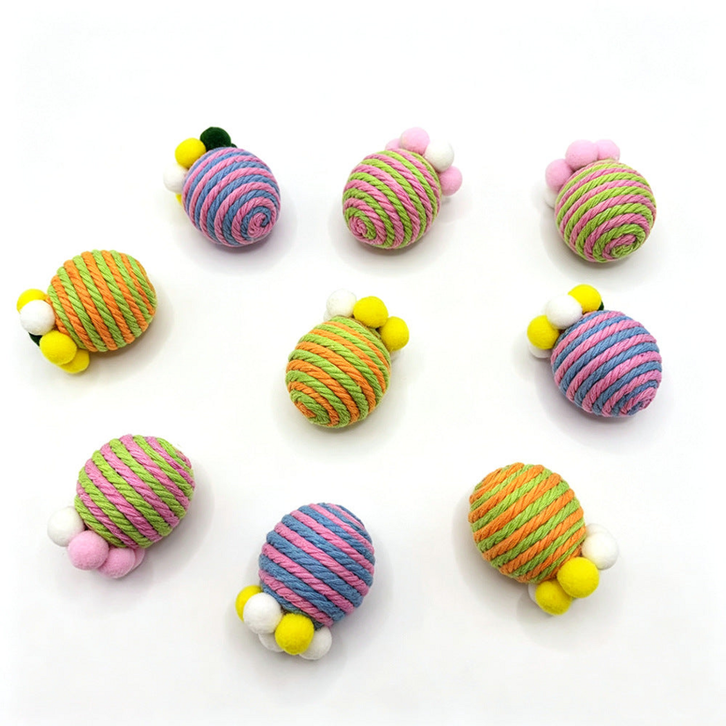 Striped cat toys with pom-poms spread separately across a white background