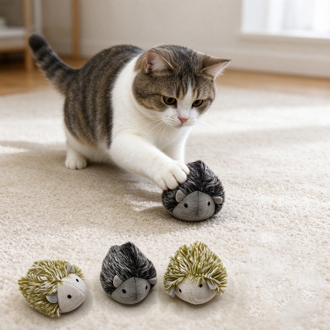 Cat touching a dark gray hedgehog-shaped toy with three other toys in the foreground