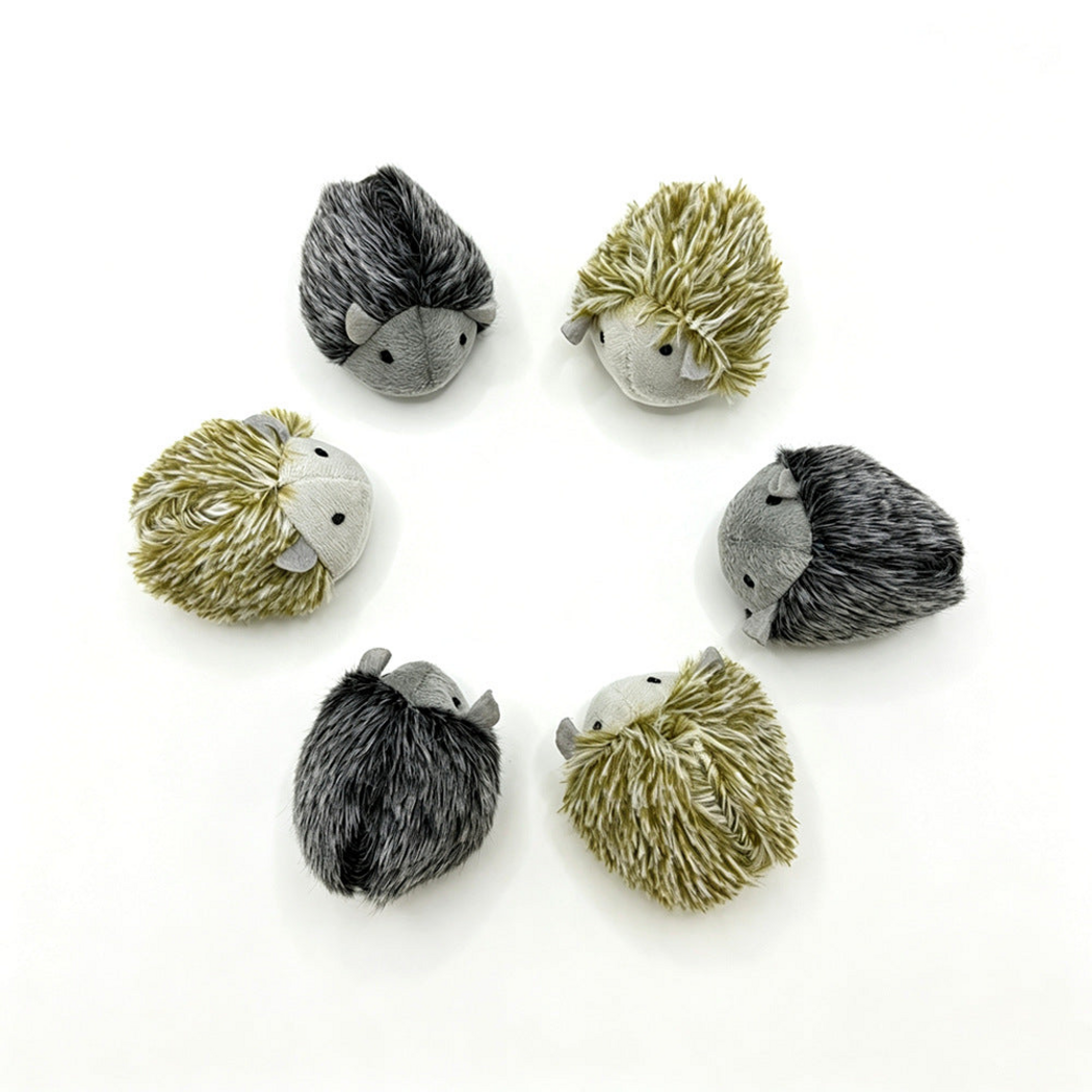 Olive-toned and dark gray hedgehog-shaped toys showing front, side and back views