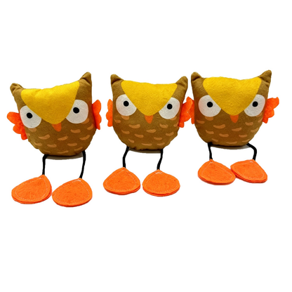 Three owl cat toys facing forward with yellow forehead patches and orange feet