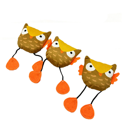 Three owl cat toys arranged diagonally with extended black cord legs and orange feet