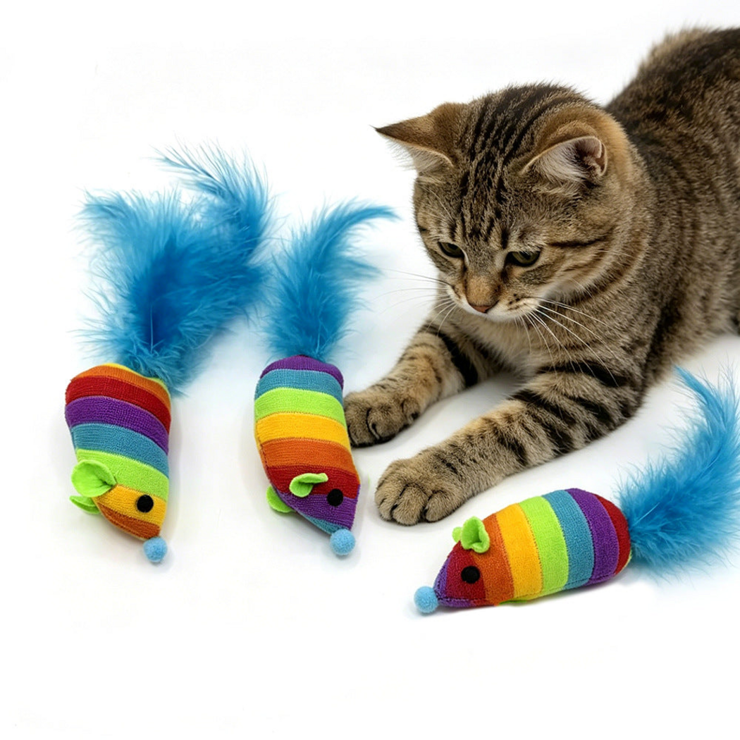 Tabby cat beside rainbow-striped mouse-shaped toys with upright blue feather tails