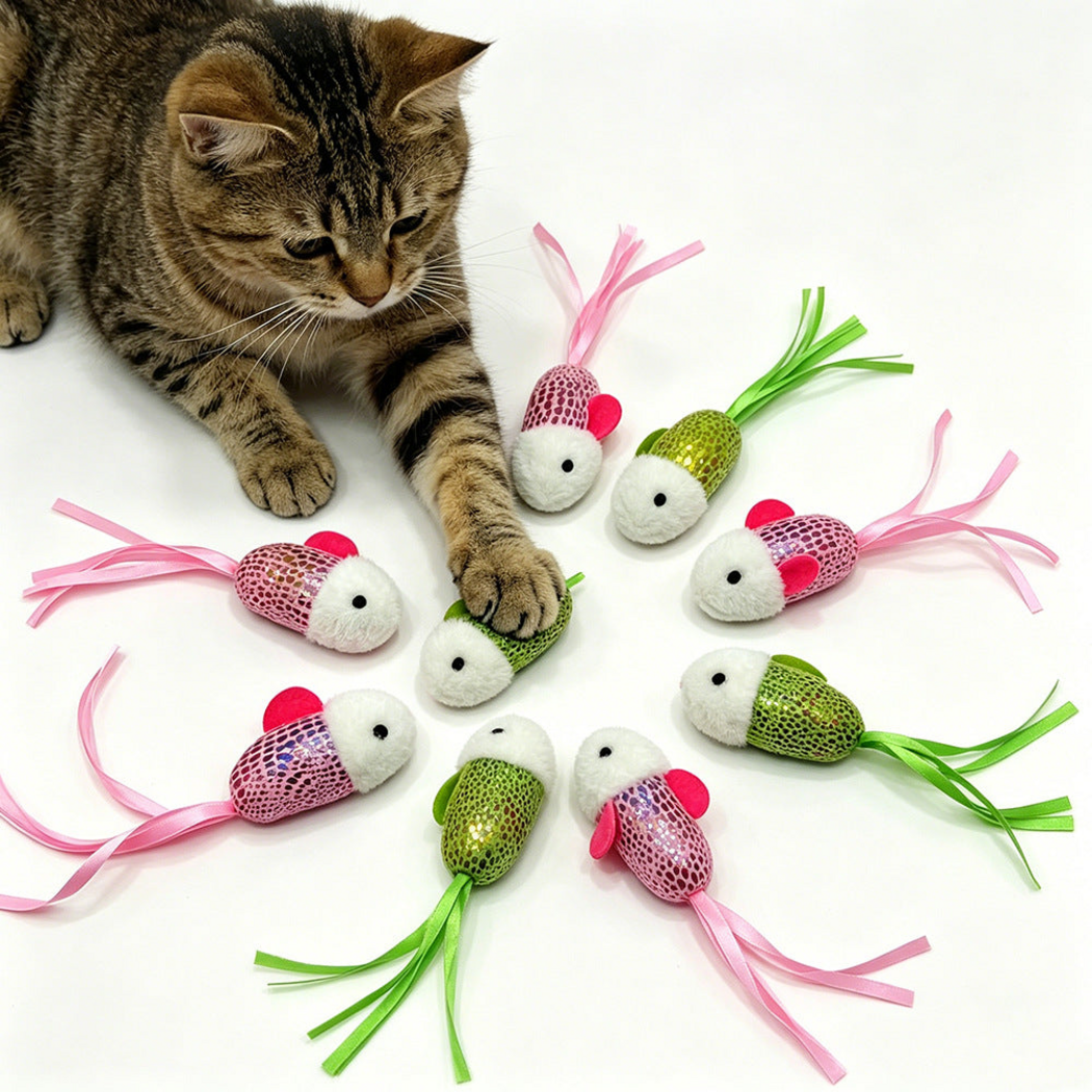 Tabby cat resting a paw among pink and green fish-shaped cat toys