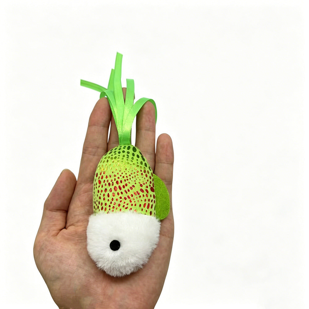 Green fish-shaped cat toy resting on an open hand