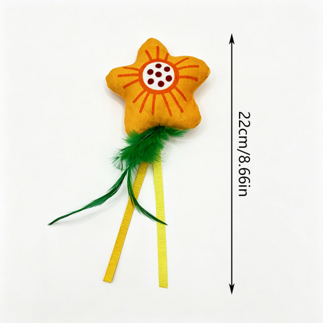 Flower cat toy with green feather-like tails, yellow ribbons and measurement information