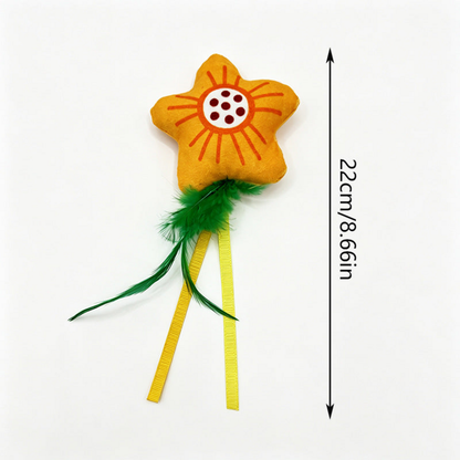 Flower cat toy with green feather-like tails, yellow ribbons and measurement information