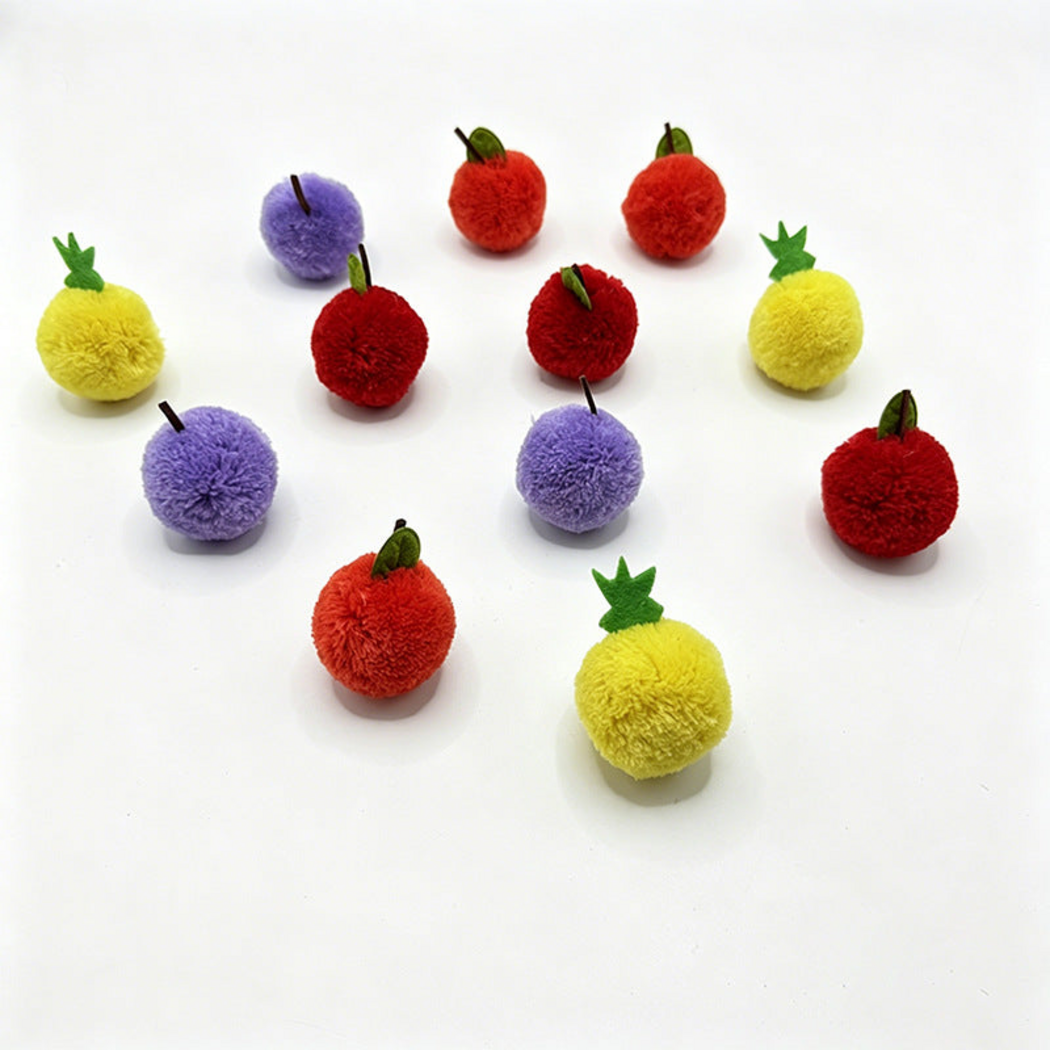 Purple, orange-red, red and yellow fruit-shaped ball cat toys displayed together