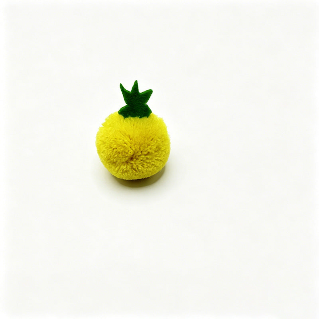 Yellow Pineapple ball cat toy with a green leafy top