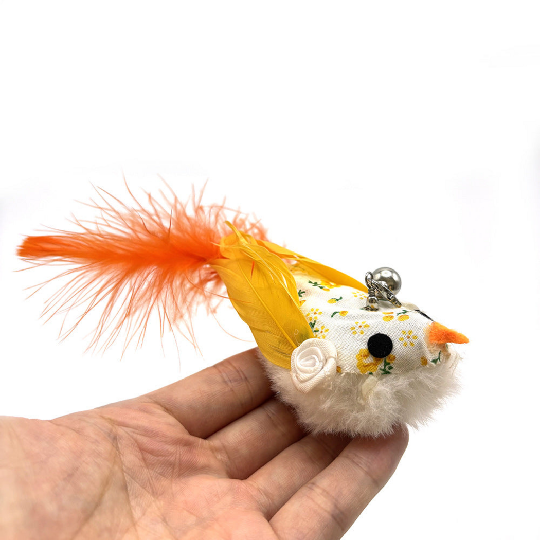 Orange bird-shaped cat wand replacement head held in a hand, showing floral print, feathers and bell