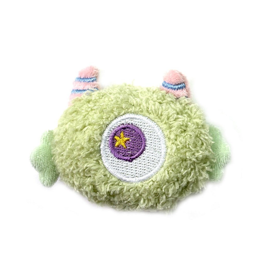 Green cat toy with a central embroidered eye and side appendages