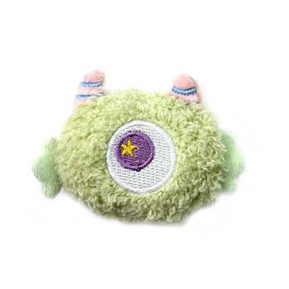 Green cat toy with a central embroidered eye and side appendages