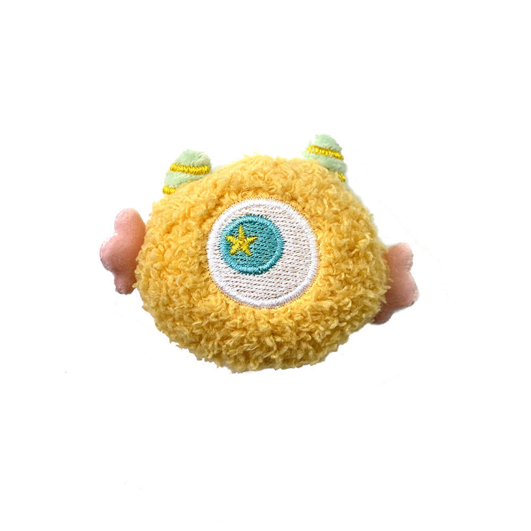 Yellow cat toy with a central embroidered eye and pink side appendages
