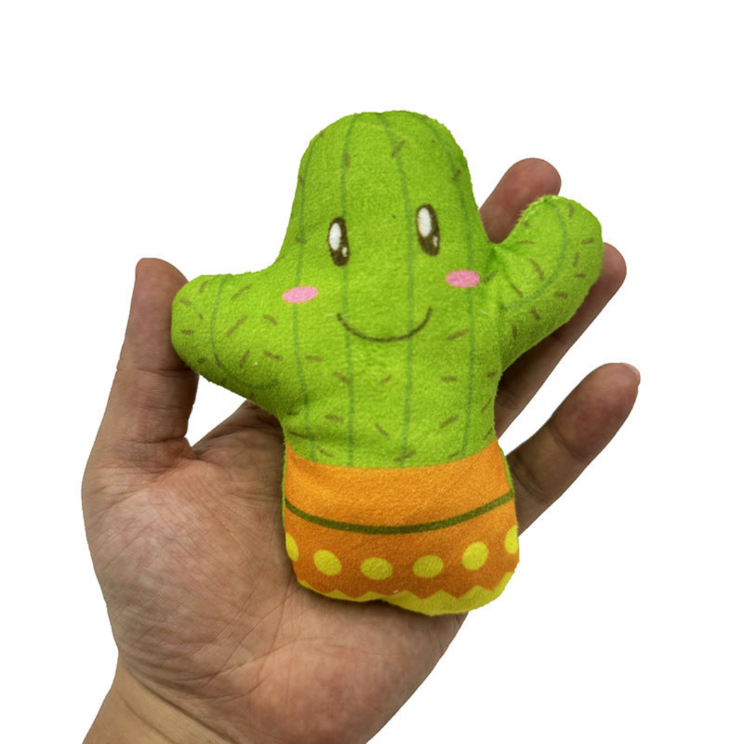 Cactus cat toy held in an open hand, showing its smiling face and orange pot design
