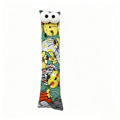 Green pillow cat toy with colorful cartoon cats, floral details and two white eyes