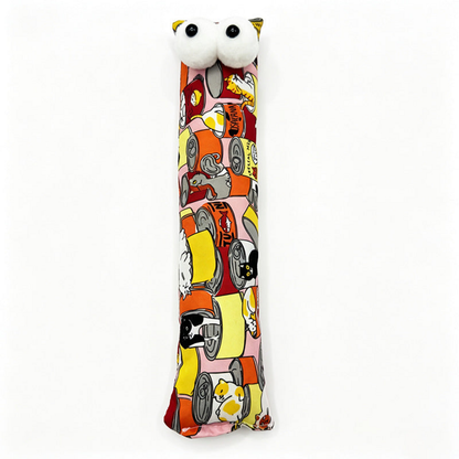Orange pillow cat toy with illustrated cats and cans and two white eyes