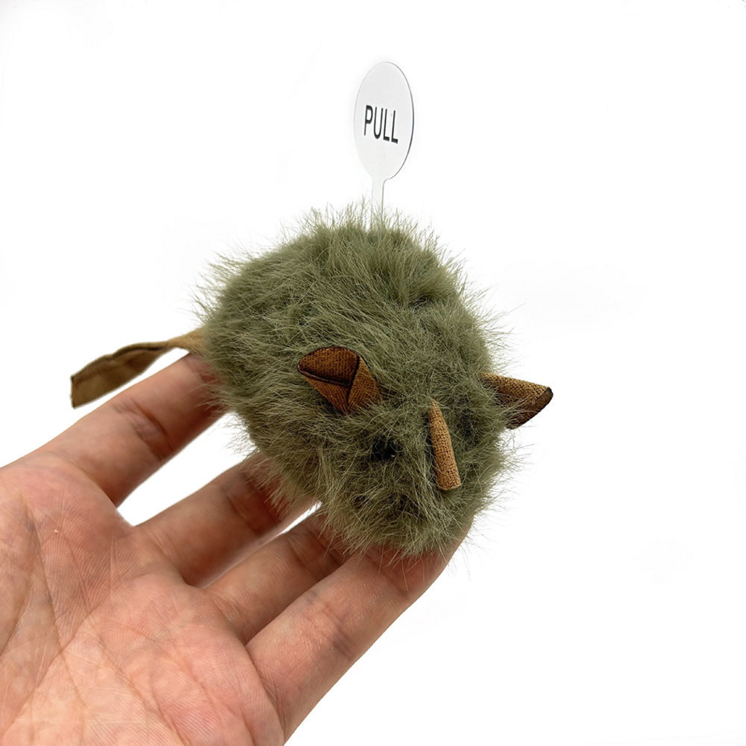 Army Green mouse-shaped cat toy held in a hand, showing its face and PULL tab