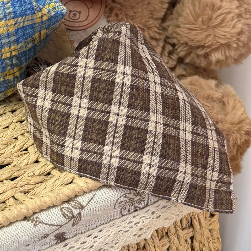 Brown plaid triangular pet neckwear with stitched edges and part of Blue neckwear behind it