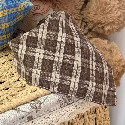 Brown plaid triangular pet neckwear with stitched edges and part of Blue neckwear behind it