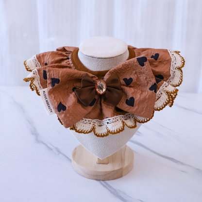Hearts Pet Neckwear with a dark brown bow and scalloped white edging, front view on a stand
