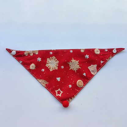 Red Bandana Pet Neckwear spread flat with cookie and snowflake motifs and visible snaps