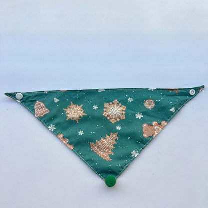 Green Bandana Pet Neckwear spread flat with cookie and snowflake motifs and visible snaps