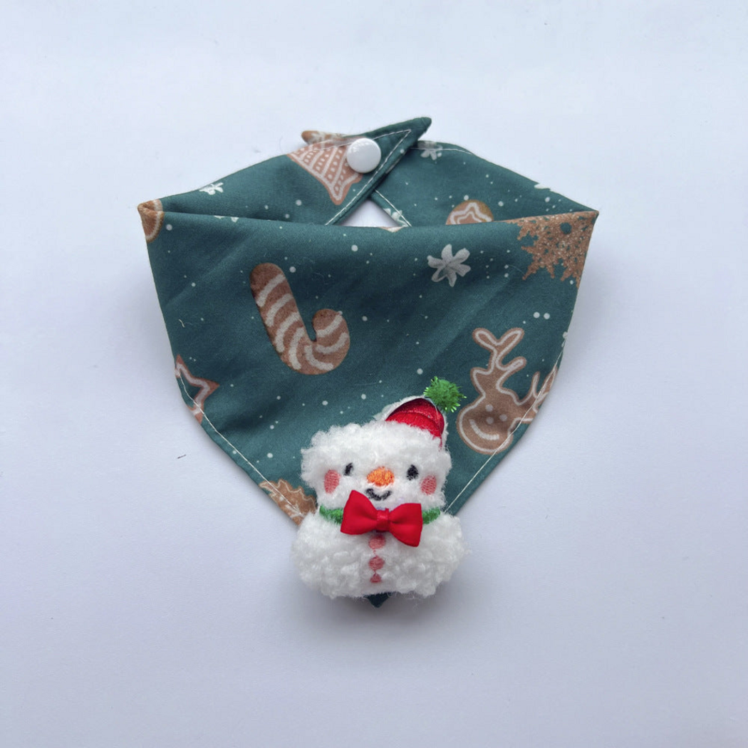 Snowman pet neckwear with teal blue patterned bandana, white snap and raised snowman charm with red bow