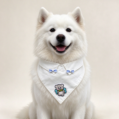 White dog wearing Blue Pet Neckwear with blue gingham bows and a bear appliqué