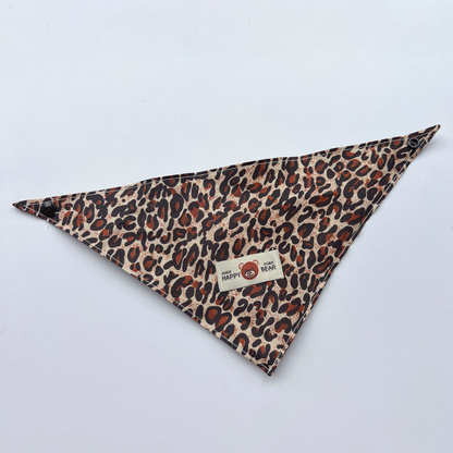 Brown leopard-print triangular pet neckwear laid flat with corner snaps and bear label
