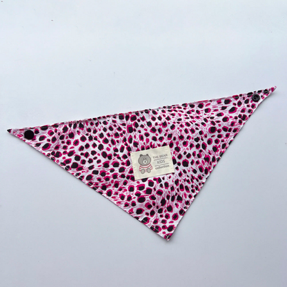 Pink leopard-print triangular pet neckwear laid flat with corner snaps and bear label