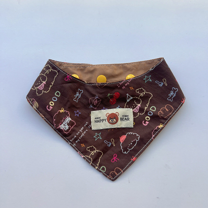 Bandana pet neckwear with brown cartoon print, cream bear patch, tan lining and yellow snaps