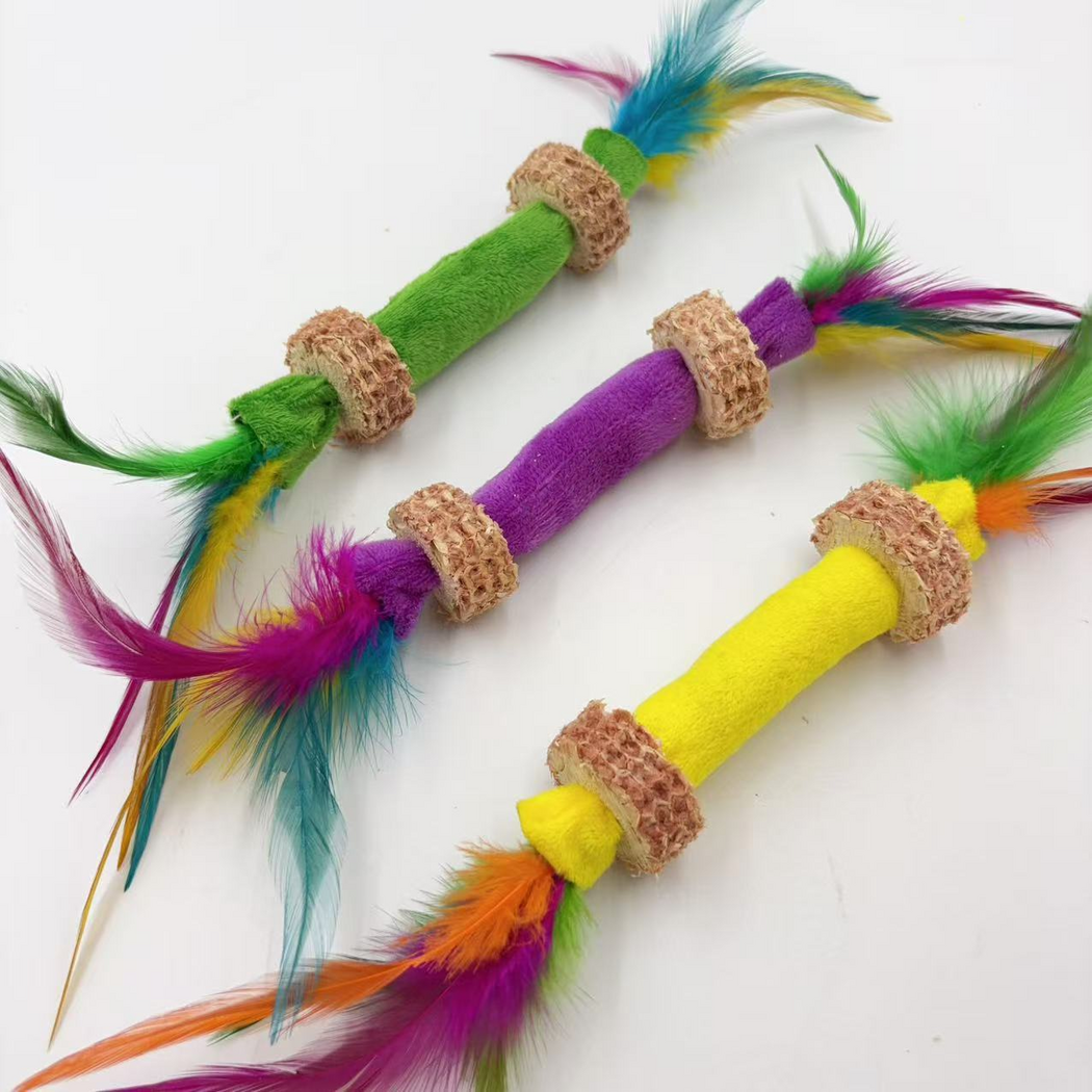 Angled close view of Green, Purple and Yellow feather stick cat toys and their textured rings