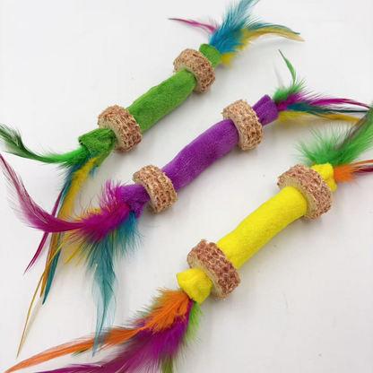 Angled close view of Green, Purple and Yellow feather stick cat toys and their textured rings