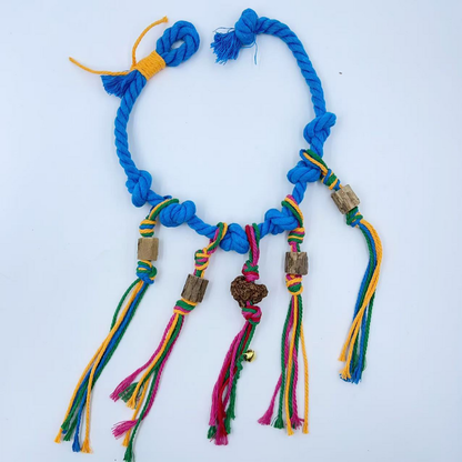 Blue knotted rope cat toy laid flat with multicolored tassels and four cylindrical pieces