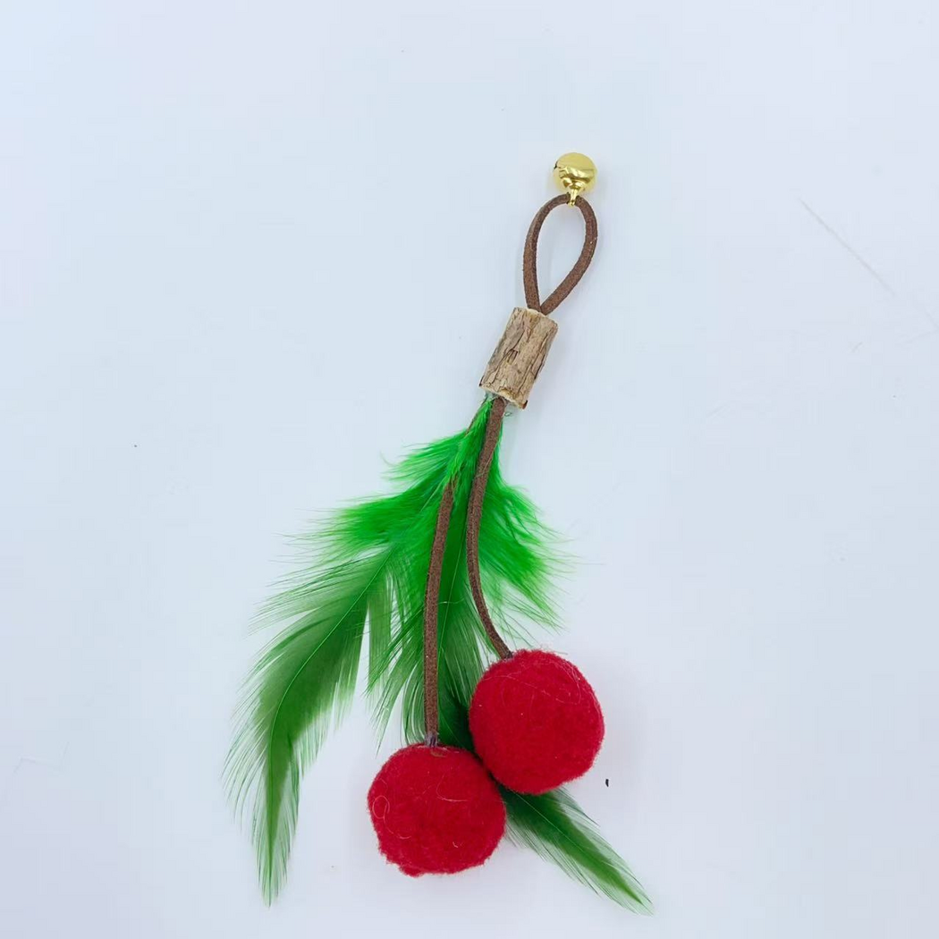 Attachment cat toy with two red fuzzy balls, green feathers and a brown cord